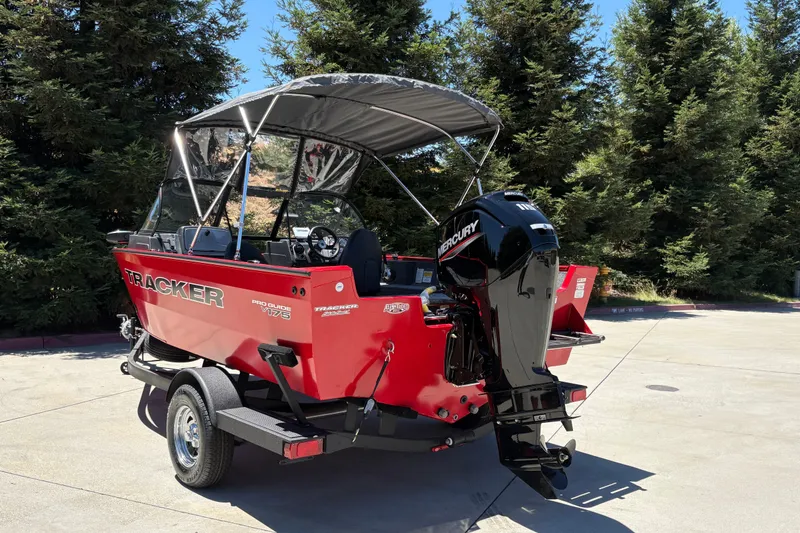 Slide: The Image of 2026 Tracker Pro Guide V-175 WT boat with Mercury engine, parked outdoors. - 9