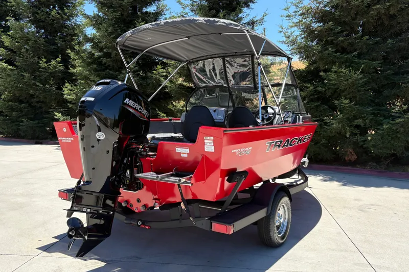 Slide: The Image of 2026 Tracker Pro Guide V-175 WT boat with Mercury engine, parked outdoors. - 10