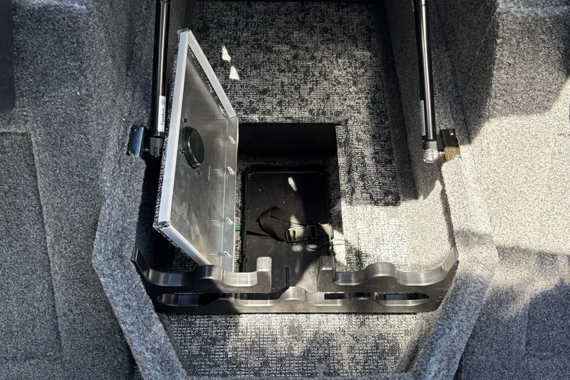 Slide: The Image of 2026 Tracker Pro Guide V-175 WT boat storage compartment with open hatch and carpeted interior. - 34