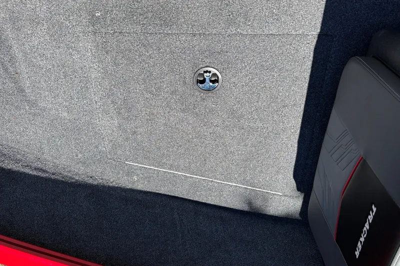 Slide: The Image of Carpeted interior of 2026 Tracker Pro Guide V-175 WT boat with storage compartment. - 43