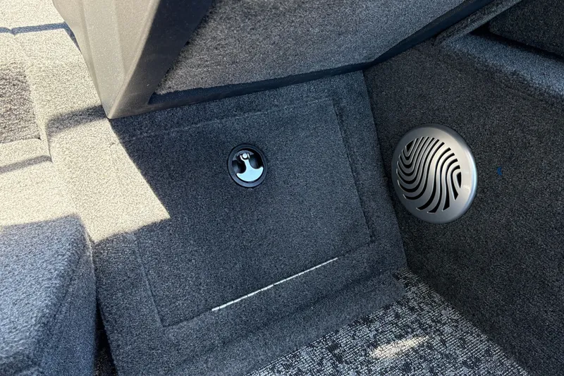 Slide: The Image of Interior view of 2026 Tracker Pro Guide V-175 WT boat, featuring carpeted flooring and speaker. - 36
