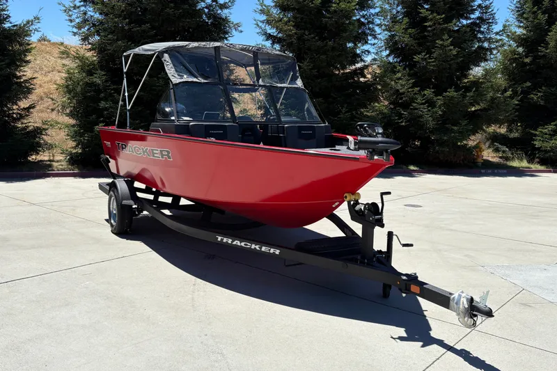 Slide: The Image of 2026 Tracker Pro Guide V-175 WT boat on trailer, parked outdoors. - 5