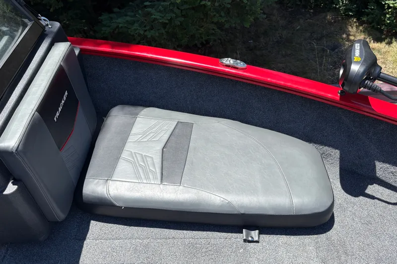 Slide: The Image of Interior of 2026 Tracker Pro Guide V-175 WT boat with gray seating and red trim. - 20