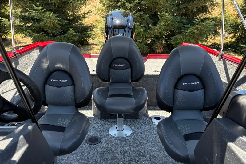 Slide: The Image of 2026 Tracker Pro Guide V-175 WT boat interior with three black seats and steering wheel. - 17