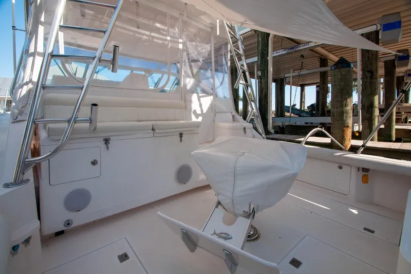 Slide: The Image of 2004 Cabo 40 Express yacht interior with Seakeeper, featuring seating and fishing chair. - 12