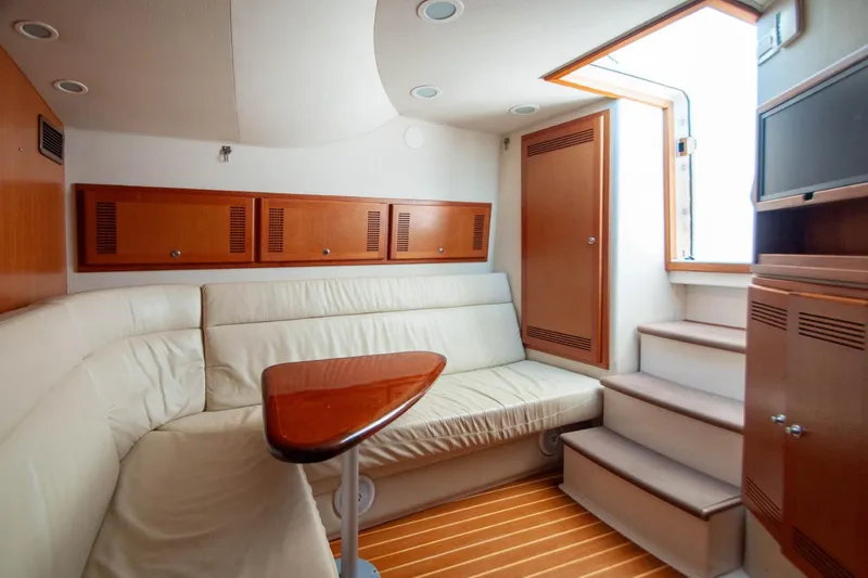 Slide: The Image of Luxurious interior of 2004 Cabo 40 Express yacht with Seakeeper, featuring elegant seating and wood finishes. - 18