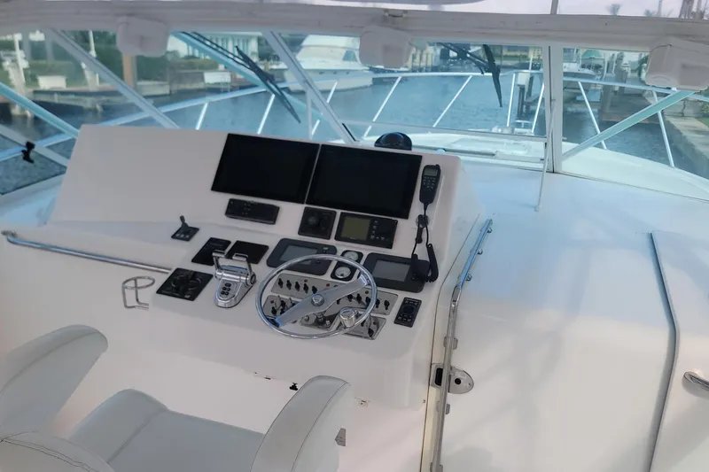 Slide: The Image of Helm of 2004 Cabo 40 Express yacht with modern navigation equipment. - 6