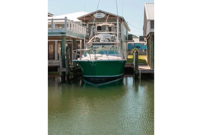 Slide: The Image of 2004 Cabo 40 Express with Seakeeper docked at marina, front view. - 9