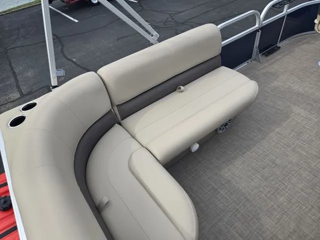 Slide: The Image of 2025 Sun Tracker Bass Buggy 16 XL Select pontoon boat with beige seating and cup holders. - 19