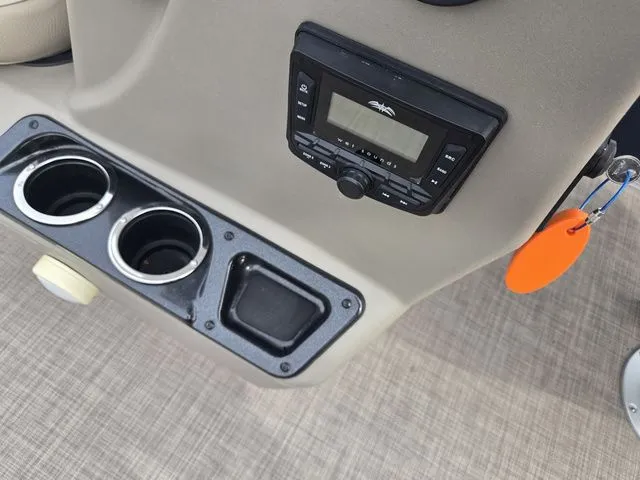 Slide: The Image of Control panel of 2025 Sun Tracker Bass Buggy 16 XL Select with cup holders and key. - 22