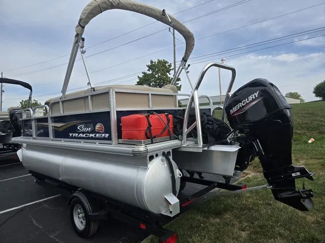 Slide: The Image of 2025 Sun Tracker Bass Buggy 16 XL Select pontoon boat with Mercury outboard motor. - 4