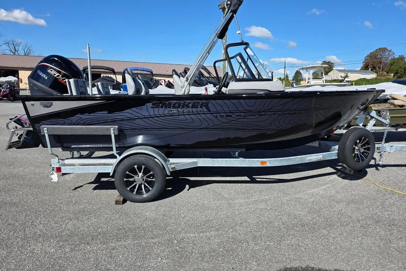 The Image of 2026 Smoker Craft Adventurer 178 DC boat on trailer, sleek black design, Yamaha engine. - 0