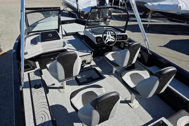Slide: The Image of 2026 Smoker Craft Adventurer 178 DC boat interior with four seats and steering console. - 12