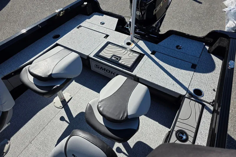 Slide: The Image of 2026 Smoker Craft Adventurer 178 DC boat interior with seating and storage compartments. - 13
