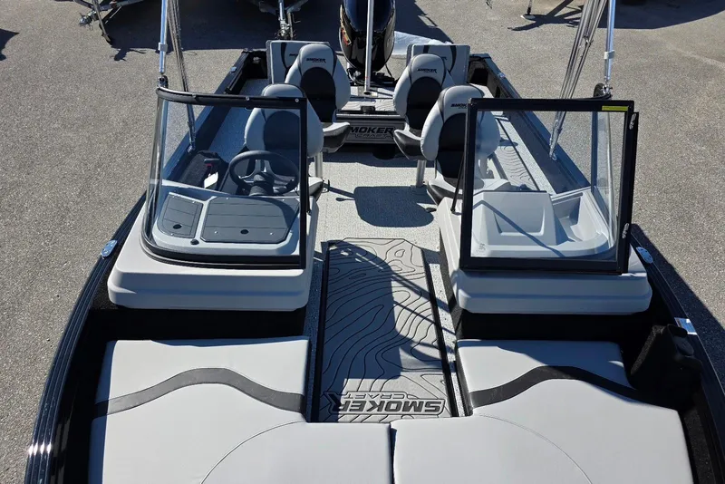Slide: The Image of 2026 Smoker Craft Adventurer 178 DC boat interior with seating and steering console. - 15