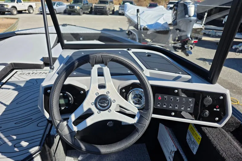 Slide: The Image of 2026 Smoker Craft Adventurer 178 DC boat dashboard with steering wheel and control panel. - 17