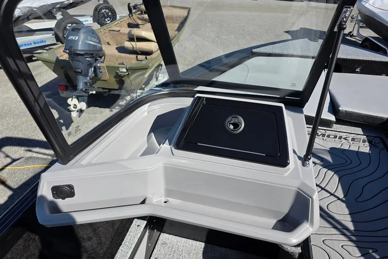 Slide: The Image of 2026 Smoker Craft Adventurer 178 DC boat interior with windshield and storage compartment. - 20