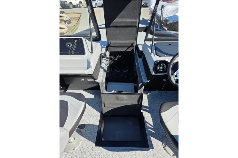 Slide: The Image of 2026 Smoker Craft Adventurer 178 DC boat interior with open storage compartments. - 22