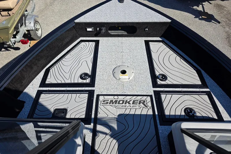 Slide: The Image of 2026 Smoker Craft Adventurer 178 DC boat interior with storage compartments and textured flooring. - 25