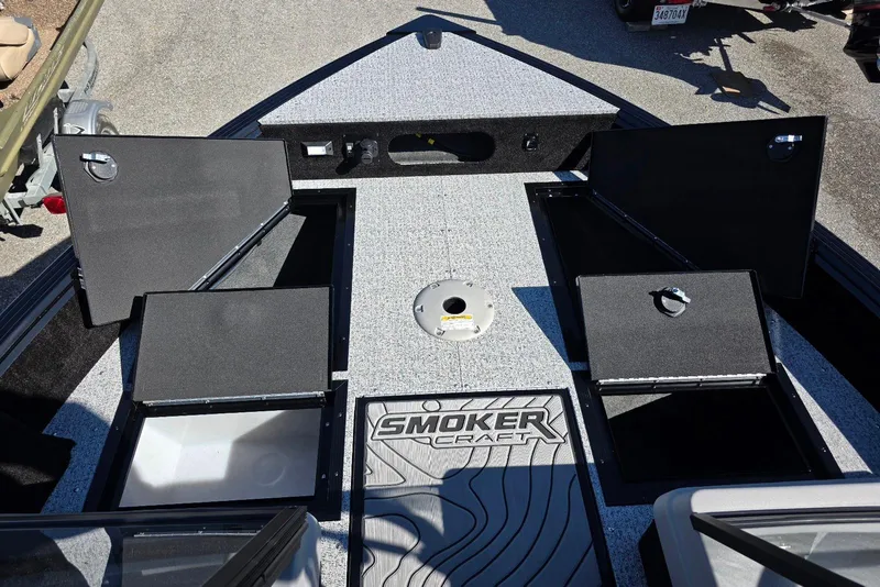 Slide: The Image of 2026 Smoker Craft Adventurer 178 DC boat with open storage compartments. - 26