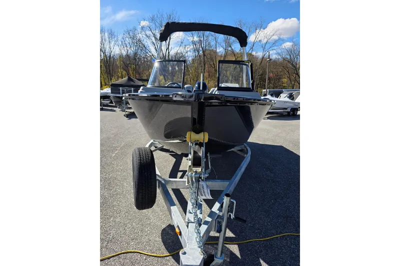 Slide: The Image of 2026 Smoker Craft Adventurer 178 DC boat on trailer, parked outdoors. - 4