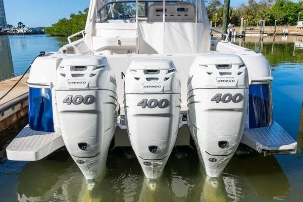 Slide: The Image of 2023 Intrepid 438 Evolution with triple 400 Verado engines docked at marina. - 10