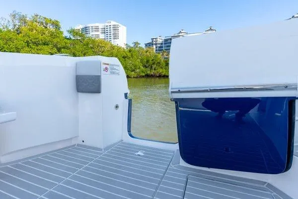 Slide: The Image of 2023 Intrepid 438 Evolution boat deck with water and cityscape view. - 16