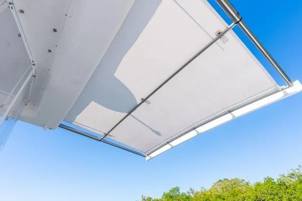 Slide: The Image of 2023 Intrepid 438 Evolution boat canopy against clear blue sky. - 18