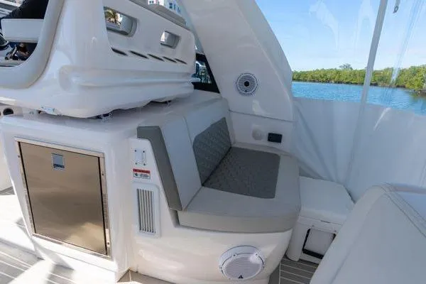 Slide: The Image of 2023 Intrepid 438 Evolution boat interior with seating and storage, featuring modern design elements. - 21