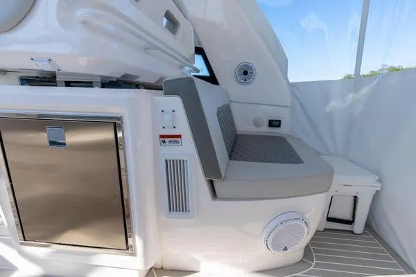 Slide: The Image of 2023 Intrepid 438 Evolution yacht interior with seating and stainless steel storage. - 23