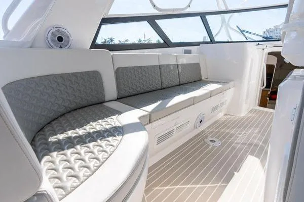 Slide: The Image of Luxurious seating area on 2023 Intrepid 438 Evolution yacht, featuring elegant design and ample sunlight. - 24