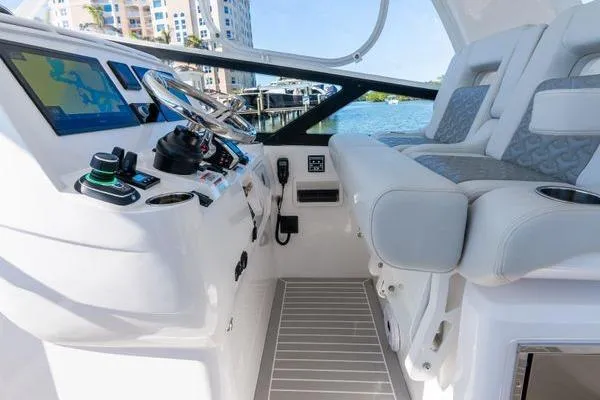 Slide: The Image of 2023 Intrepid 438 Evolution boat cockpit with modern controls and plush seating. - 26