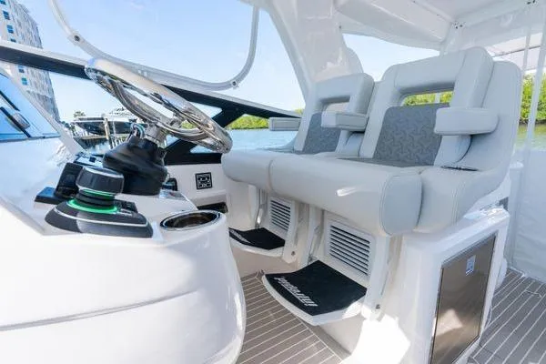 Slide: The Image of 2023 Intrepid 438 Evolution boat interior with modern helm and seating. - 29