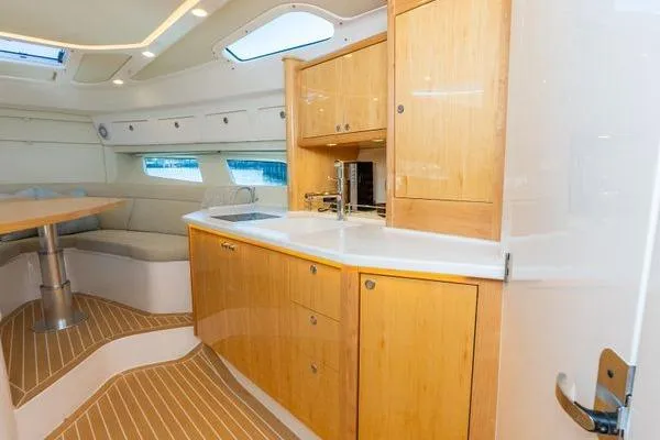 Slide: The Image of Luxurious interior of 2023 Intrepid 438 Evolution yacht with modern kitchen and seating area. - 34