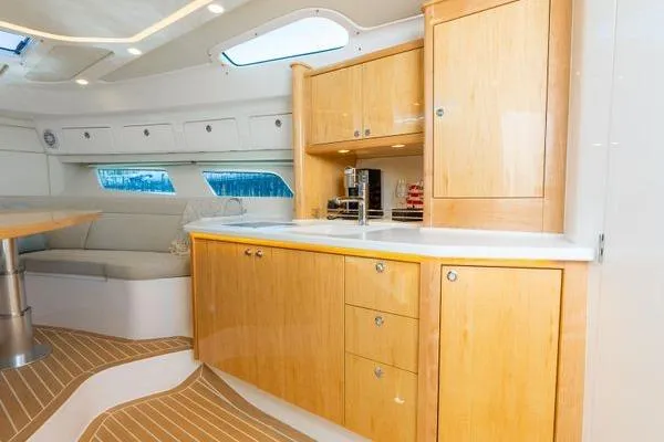 Slide: The Image of Luxurious 2023 Intrepid 438 Evolution yacht interior with modern kitchen and seating area. - 35