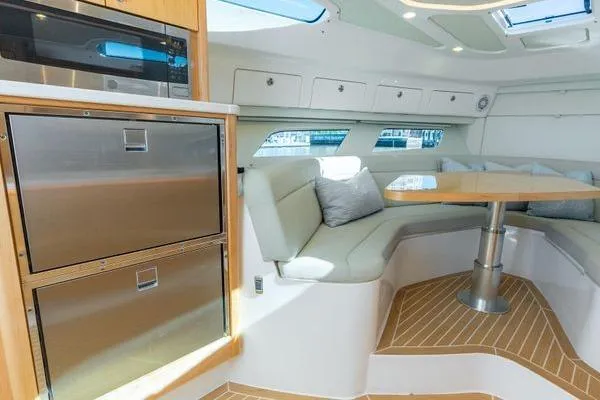 Slide: The Image of Luxurious interior of 2023 Intrepid 438 Evolution yacht with modern seating and kitchen area. - 36