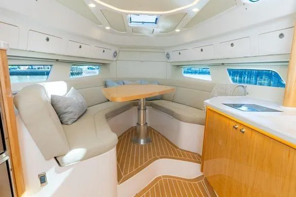 Slide: The Image of Luxurious interior of 2023 Intrepid 438 Evolution yacht with elegant seating and wooden accents. - 37