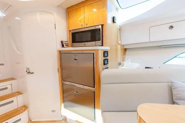 Slide: The Image of Interior of 2023 Intrepid 438 Evolution yacht with modern kitchen and seating area. - 40