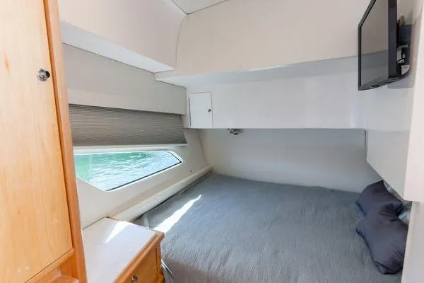 Slide: The Image of 2023 Intrepid 438 Evolution cabin interior with bed, window, and TV. - 41