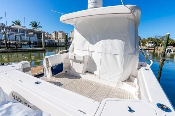 Slide: The Image of 2023 Intrepid 438 Evolution yacht docked in a sunny marina setting. - 5