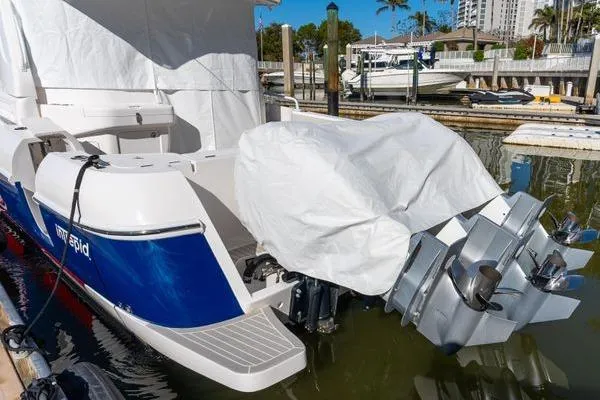 Slide: The Image of 2023 Intrepid 438 Evolution boat docked with covered engines. - 9