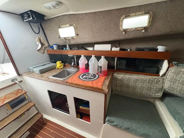 Slide: The Image of Interior of a 1986 Luhrs Alura yacht with kitchenette and seating area. - 4