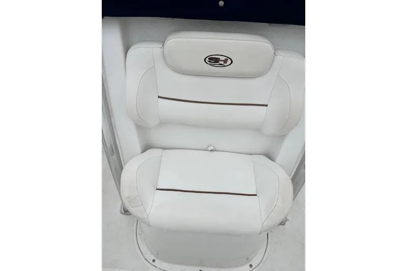 Slide: The Image of 2018 Sea Hunt Ultra 211 boat seat with white upholstery and logo. - 11