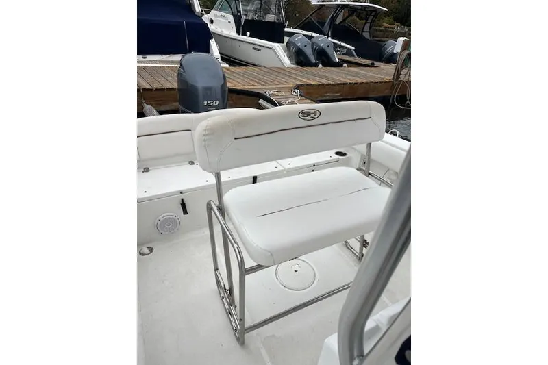Slide: The Image of 2018 Sea Hunt Ultra 211 boat with white seating and Yamaha 150 engine. - 12