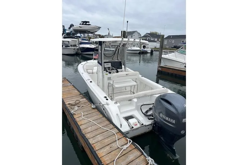 Slide: The Image of 2018 Sea Hunt Ultra 211 boat docked with Yamaha outboard motor. - 15