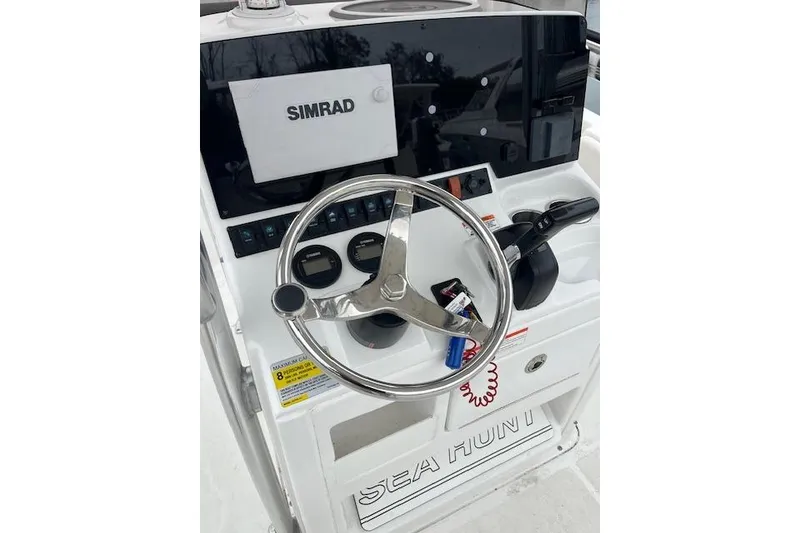 Slide: The Image of 2018 Sea Hunt Ultra 211 boat dashboard with Simrad display and steering wheel. - 4