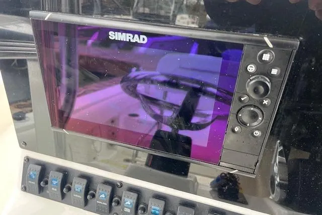 Slide: The Image of Simrad display on 2018 Sea Hunt Ultra 211 boat dashboard with control buttons. - 6