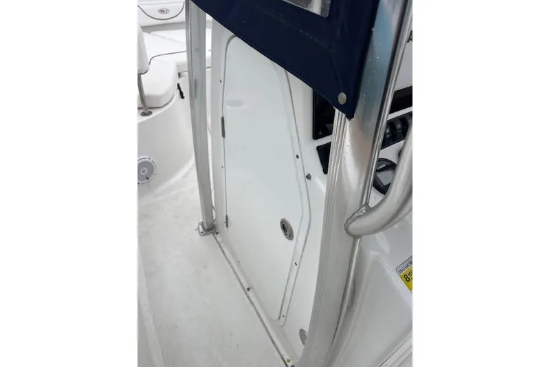 Slide: The Image of 2018 Sea Hunt Ultra 211 boat interior with white door and metal frame. - 8