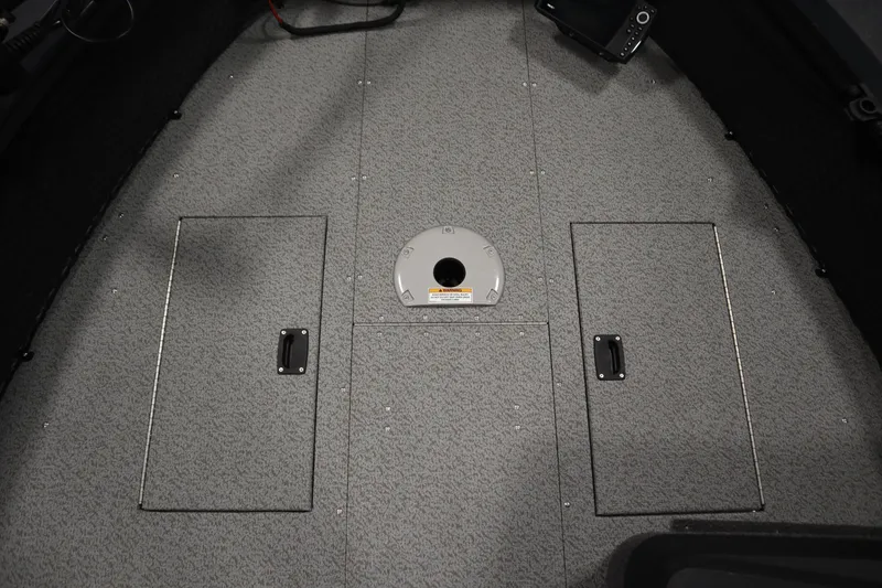 Slide: The Image of 2024 Crestliner 1750 Hawk boat interior with storage compartments and gray flooring. - 16