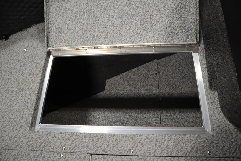 Slide: The Image of 2024 Crestliner 1750 Hawk storage compartment with open hatch, showcasing interior space. - 17